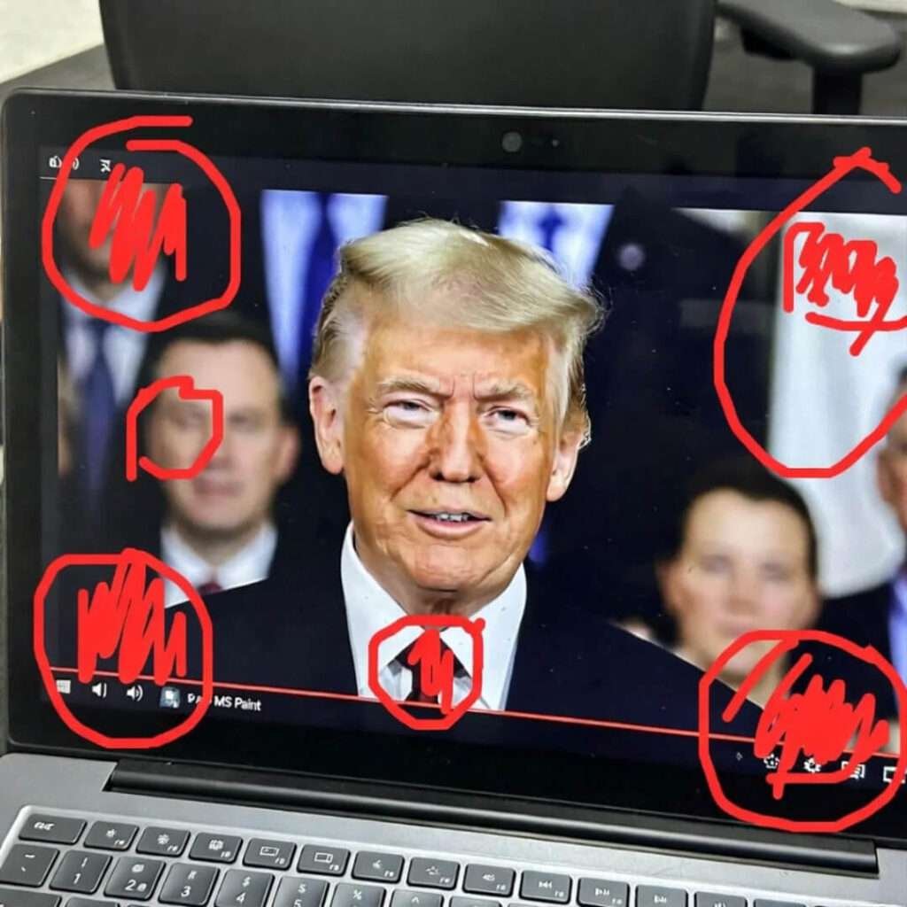 Grainy laptop screenshot: deep fake face swap on politician, red MS Paint circles.