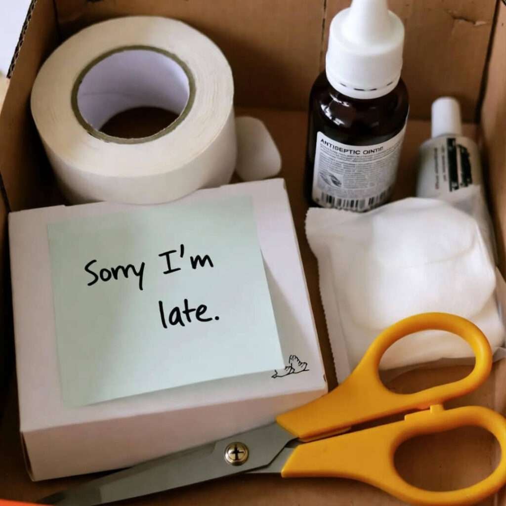 Shoebox aid: bandages with "Sorry I'm late" note, doodled doves. Bittersweet amber hope.